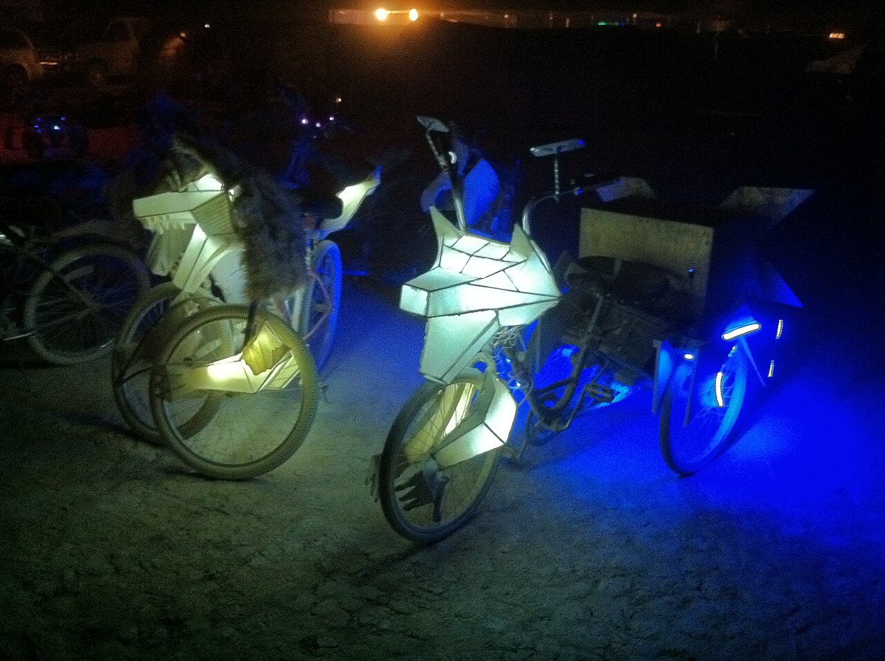 Elaborately decorated bicycles on the playa at Burning Man 2011. Photo by Victor Grigas, CC BY-SA 3.0, via Wikimedia Commons.