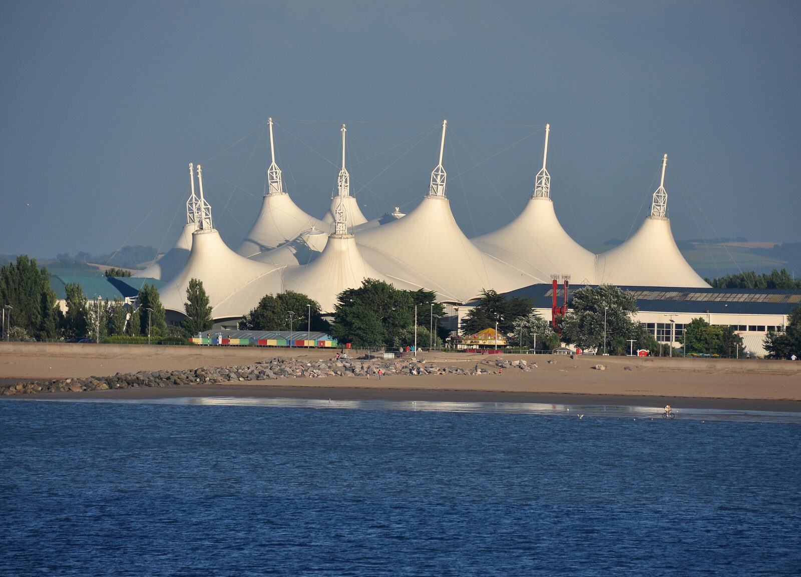 The white tented roofs of the Skyline Pavilion at Butlin's Minehead, seen across the water
