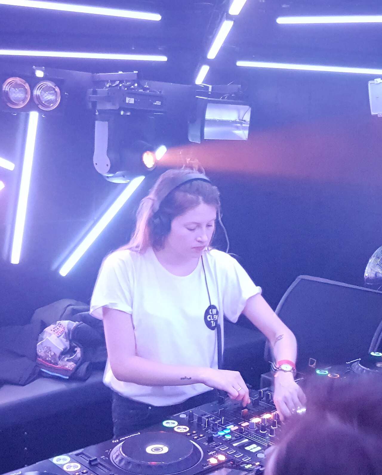 Charlotte de Witte performing behind a DJ mixer