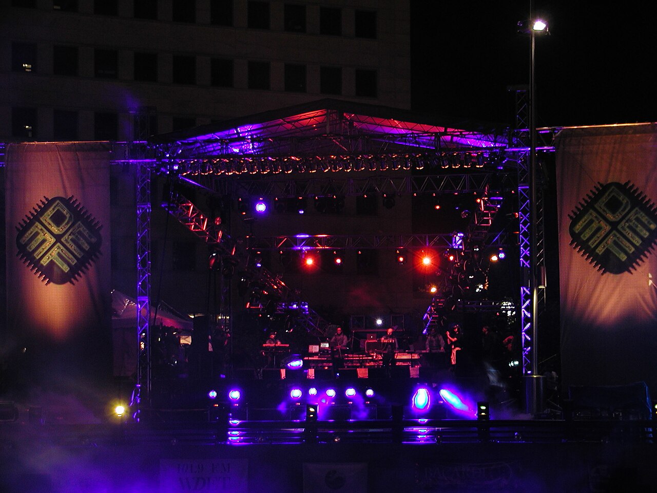 A festival main stage and crowd after dark, the scale of visibility that tends to translate directly into poll votes.