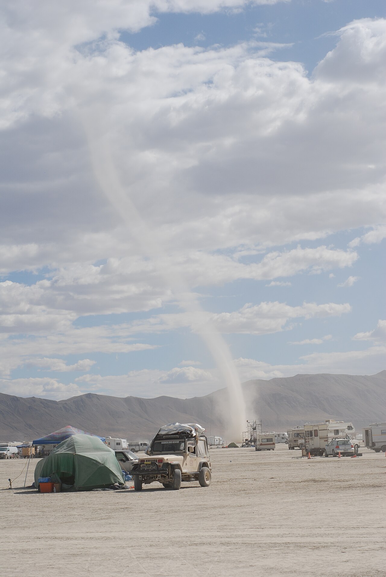 A dust devil sweeps across the playa at Burning Man 2011 in the Black Rock Desert, Nevada. Photo by Henner Zeller, licensed CC BY-SA 2.0, via Wikimedia Commons.
