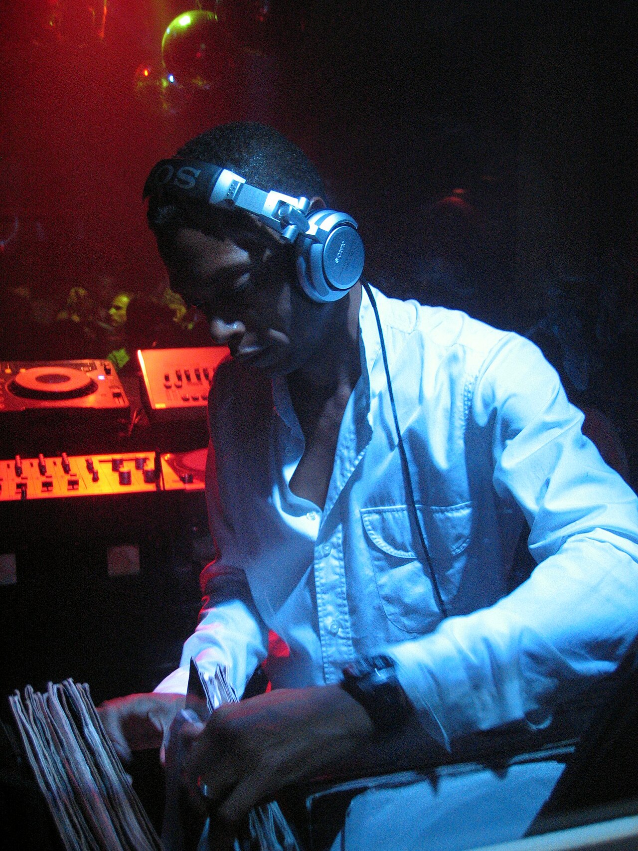 Jeff Mills DJing with headphones and vinyl records at a club event in Munich, Germany, 2006