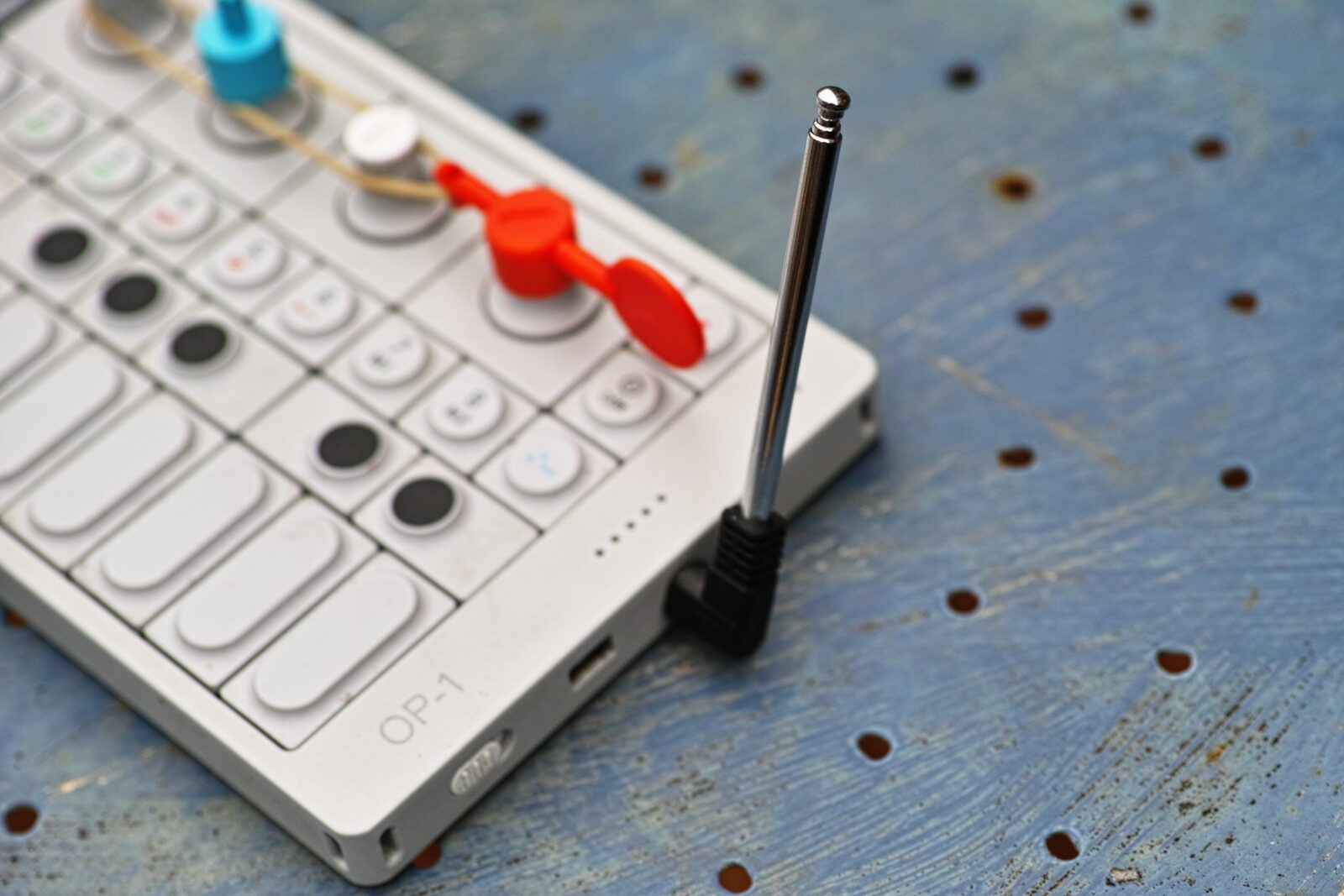 An OP-1 with a telescopic antenna plugged in for its built-in FM radio, which can be used as a sampling source